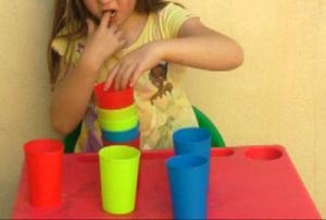 child-midline-crossing-moving-cups.jpg